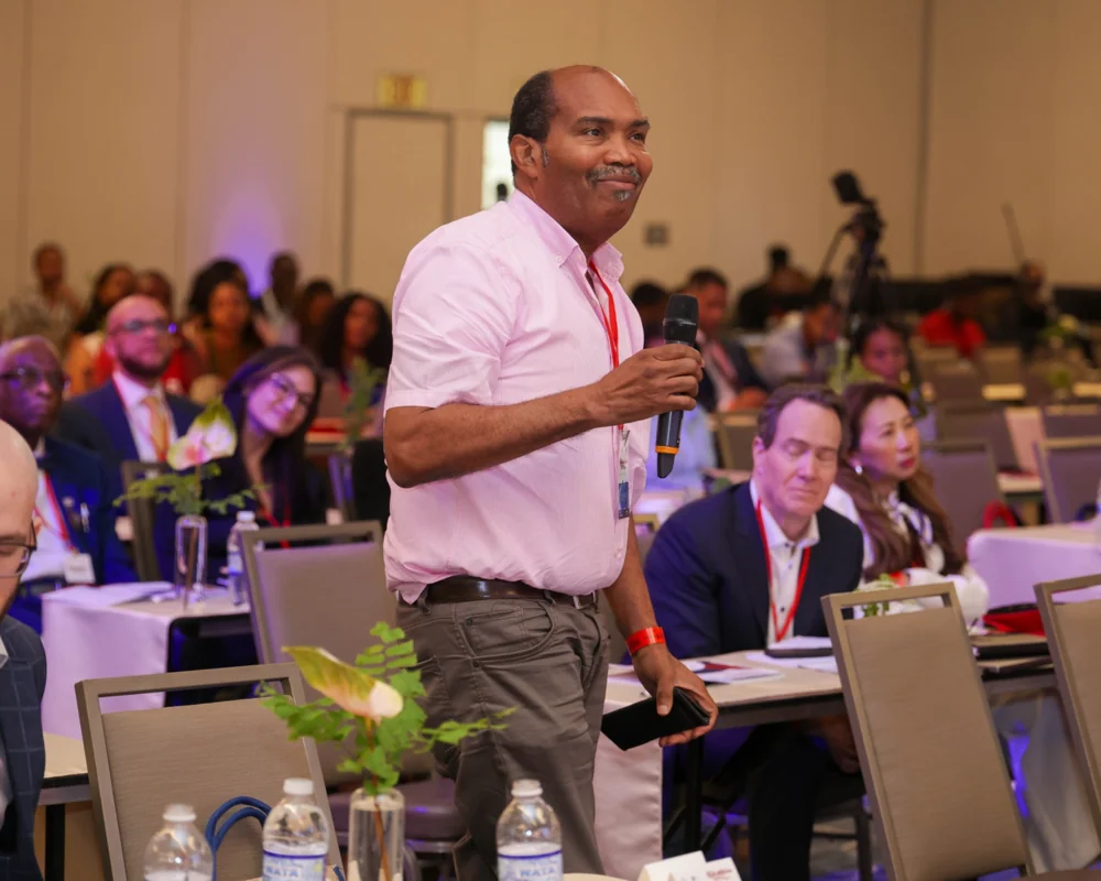 A delegate asking a question during the conference