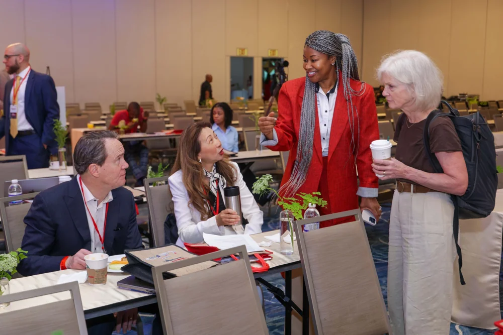 Faculty and delegates talking around a conference table
