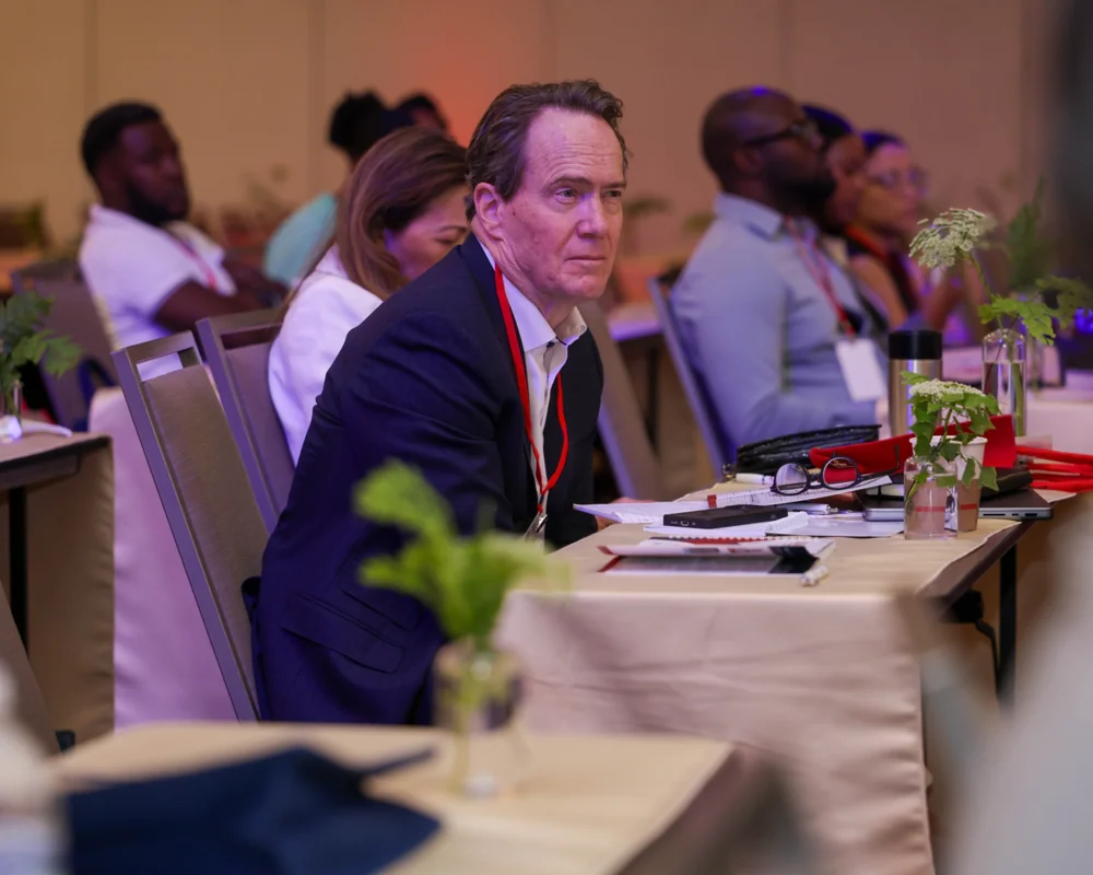 Delegates listening at conference tables