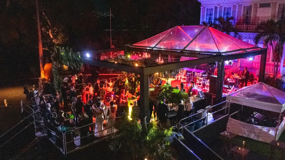 A wide view of the illuminated gala stage and guests