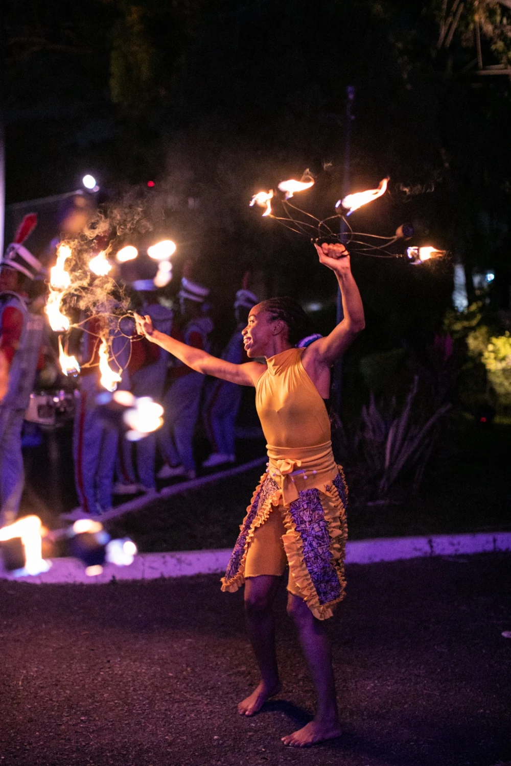 A fire performer beside the gala gardens