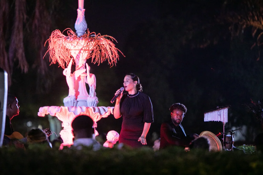 A performer beside the illuminated gala fountain