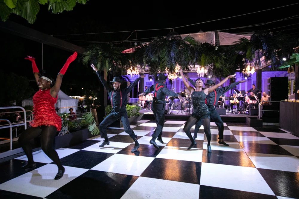 Jazz dancers performing on the checkerboard floor at the 2026 Palm Noir Gala